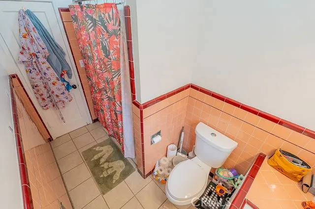 a white toilet sitting next to a bath tub