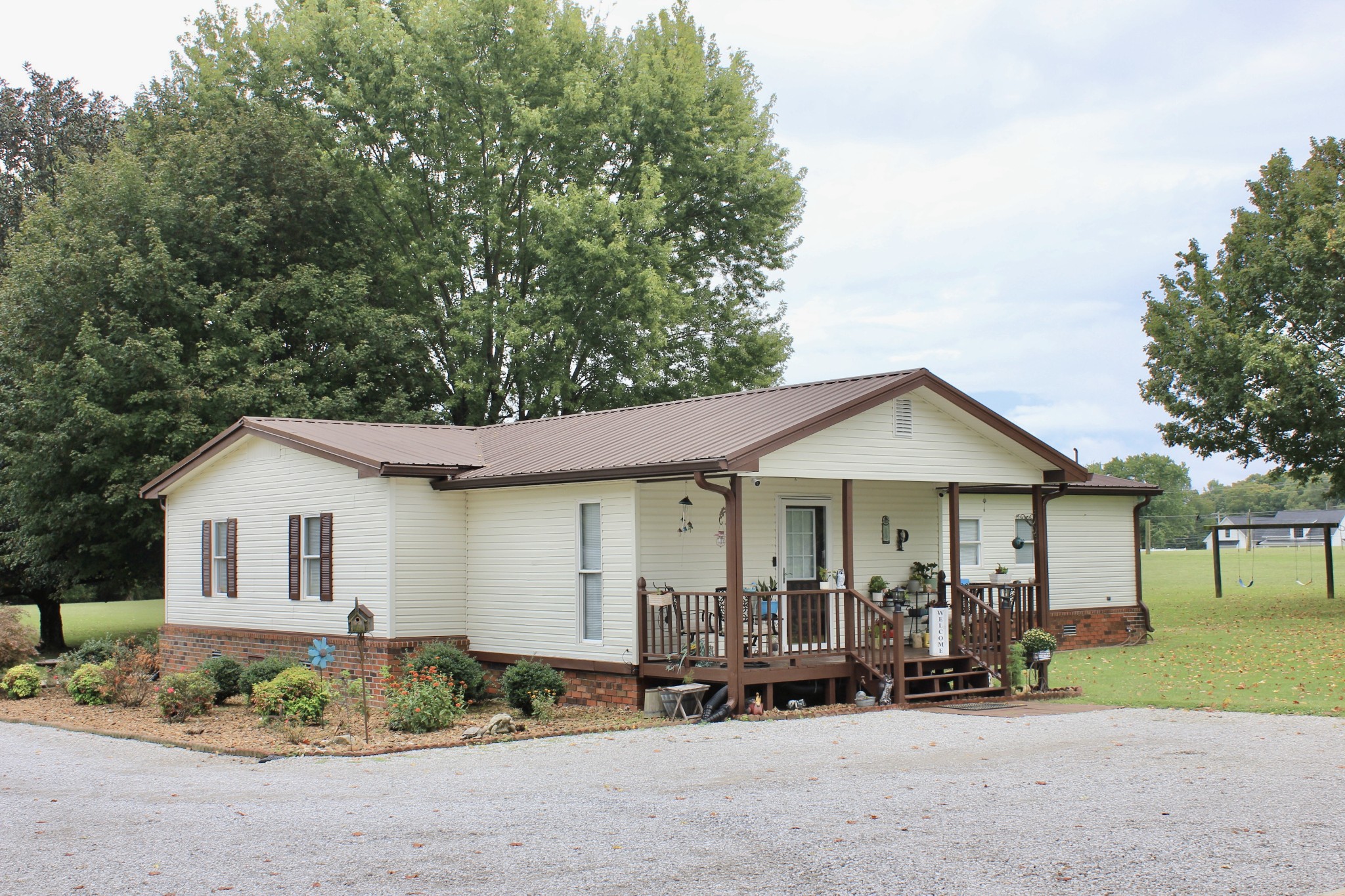 375 Nickajack Trail Monteagle, TN 37356 - Photo 7 of 34 a front view of a house with a garden and porch