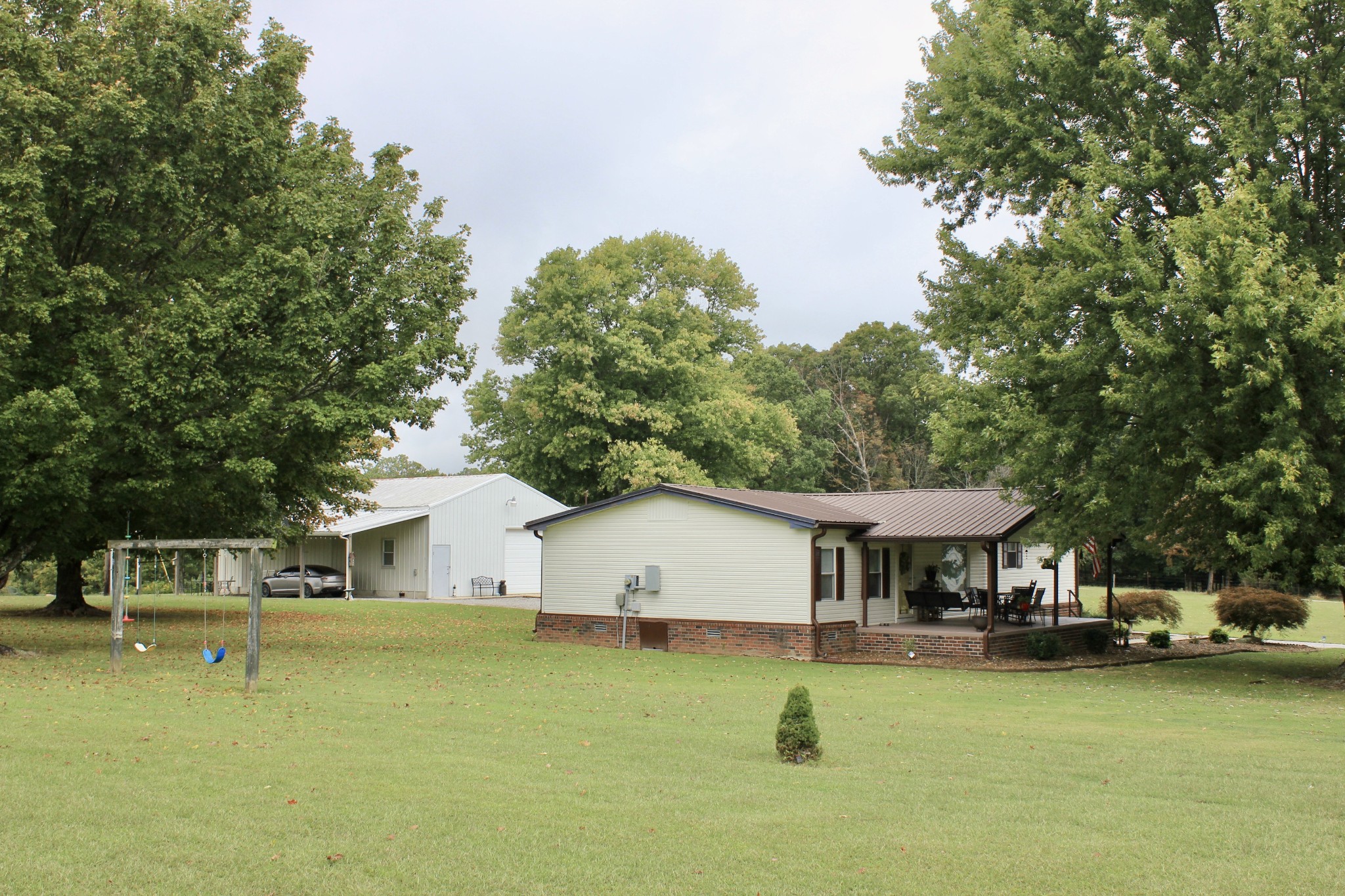 375 Nickajack Trail Monteagle, TN 37356 - Photo 10 of 34 a front view of a house with a yard table and chairs