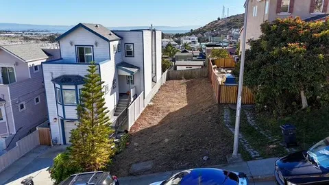a view of a house with brick walls and plants