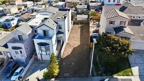 a aerial view of a residential apartment building with a yard