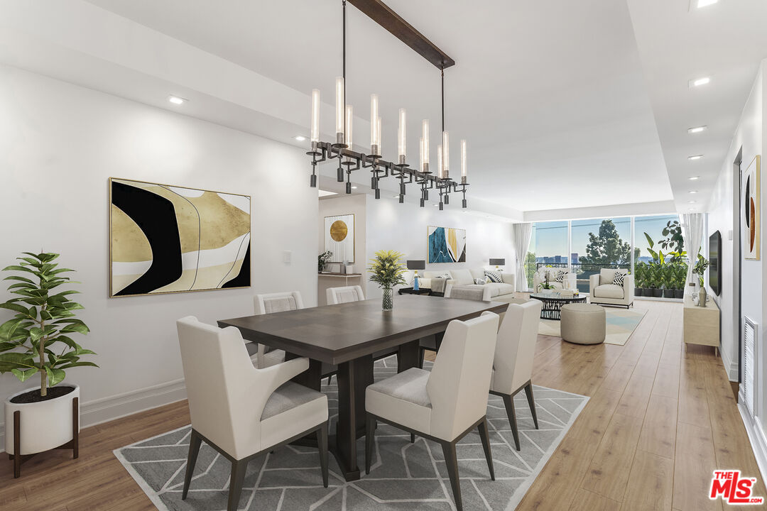 a view of a dining room with furniture wooden floor and chandelier