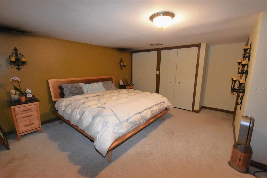 1302 Southeast Wacahoota Road Micanopy, FL 32667 - Photo 14 of 67 a large bed sitting in a room next to a window