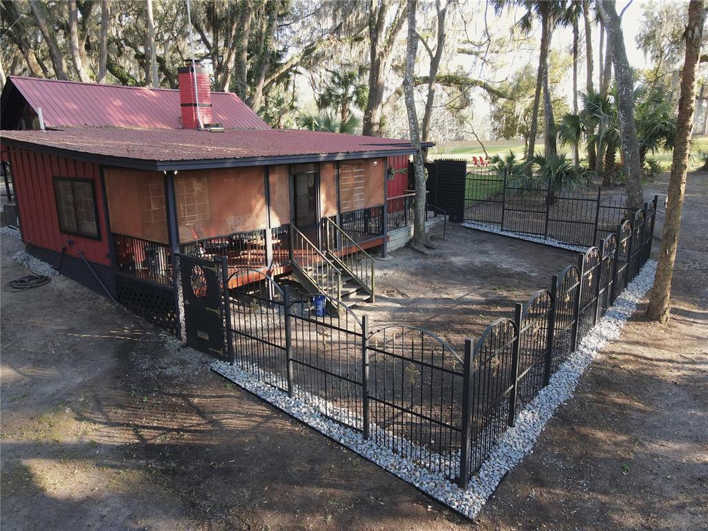 1302 Southeast Wacahoota Road Micanopy, FL 32667 - Photo 22 of 67 a view of a yard with wooden fence