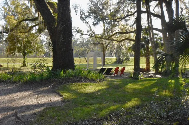 a view of kitchen with granite countertop white cabinets and window