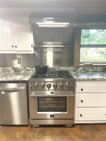 a view of a patio with table and chairs