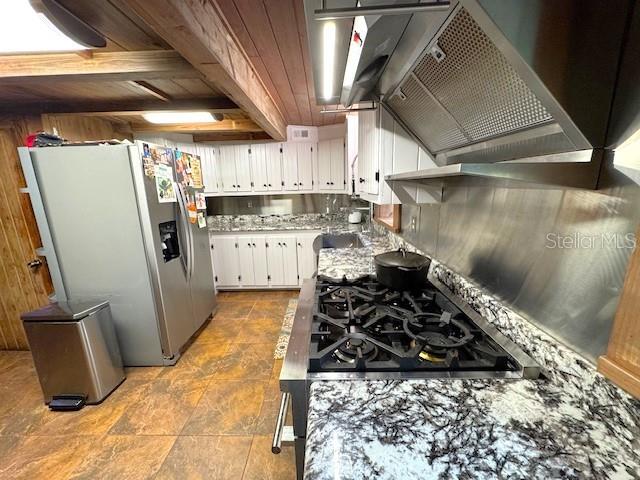 1302 Southeast Wacahoota Road Micanopy, FL 32667 - Photo 44 of 67 a kitchen with sink a stove and refrigerator