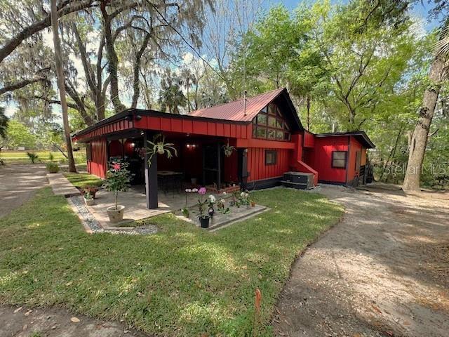 1302 Southeast Wacahoota Road Micanopy, FL 32667 - Photo 66 of 67 a front view of a house with garden
