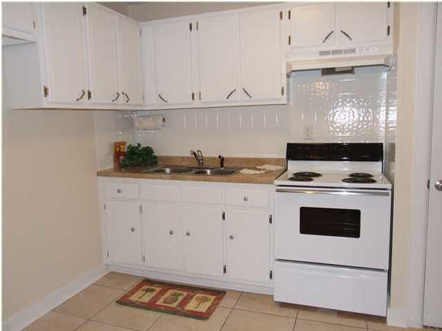 9 Milton Road Pensacola, FL 32507 - Photo 2 of 12 Kitchen open to breakfast nook. Refrigerator does remain with the home.