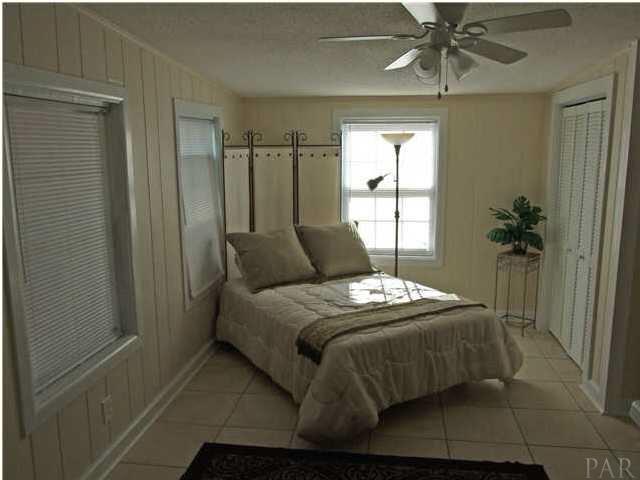 9 Milton Road Pensacola, FL 32507 - Photo 5 of 12 Master bedroom with door leading to screened porch.