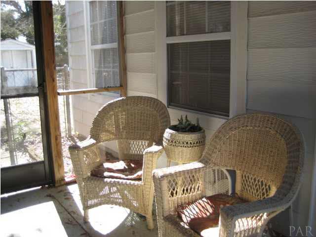 9 Milton Road Pensacola, FL 32507 - Photo 8 of 12 Screened porch. Patio furniture remains.