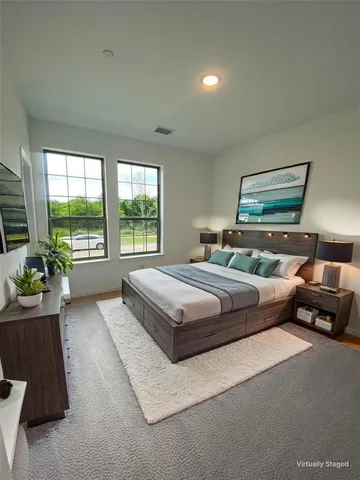 a bedroom with a bed and glass window