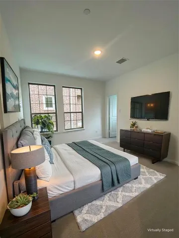 a bedroom with a bed and a television