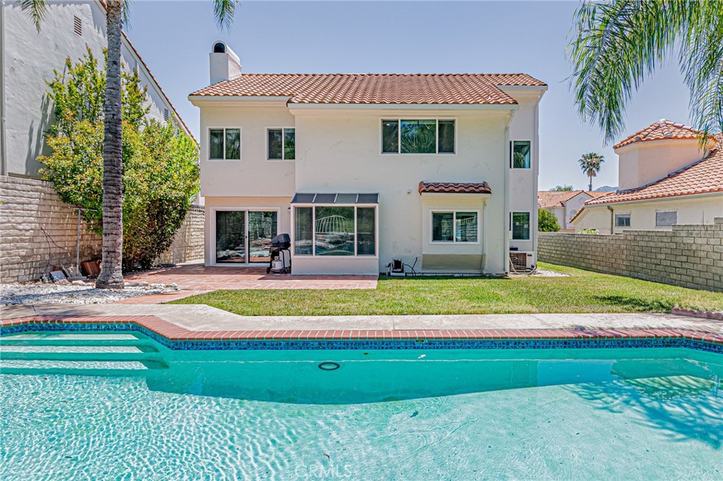 25533 Longfellow Place Stevenson Ranch, CA 91381 - Photo 2 of 47 a front view of a house with a yard