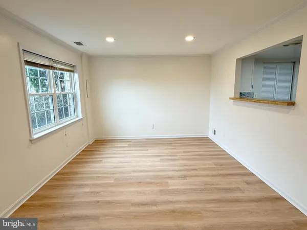 a view of a room with wooden floor