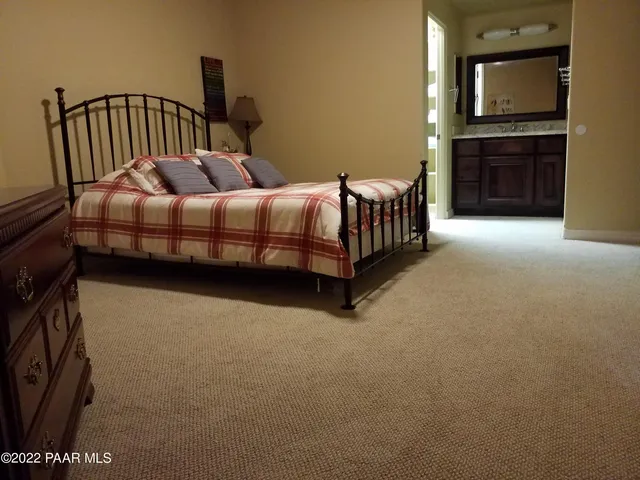 a bedroom with a bed and a television