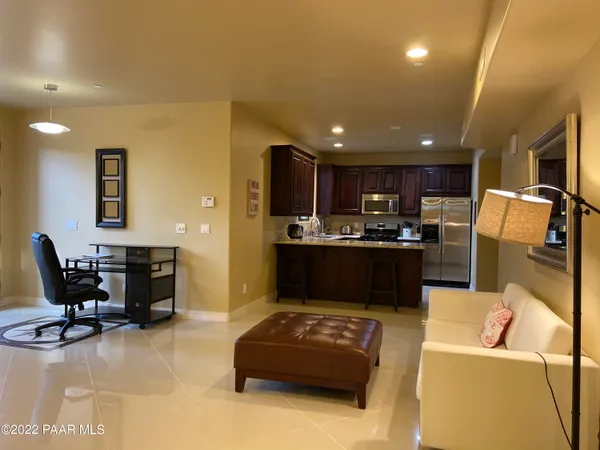 a living room with furniture and kitchen view