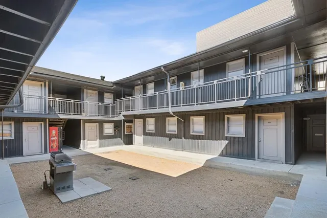 a front view of a building with a garden