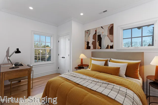 a bedroom with a bed and wooden floor