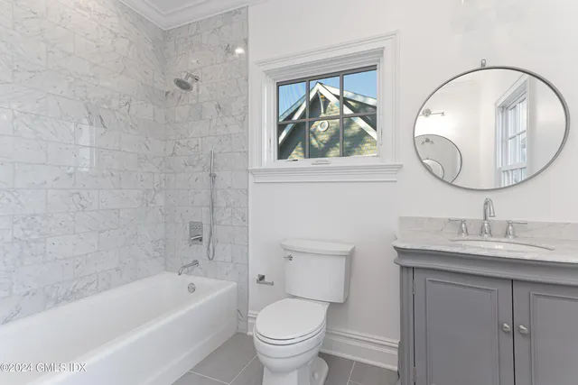 a view of a hallway with wooden floor and entryway