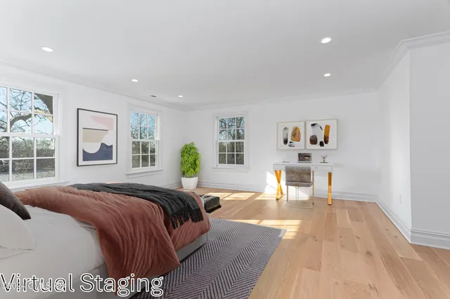 a spacious bedroom with a bed window and couch