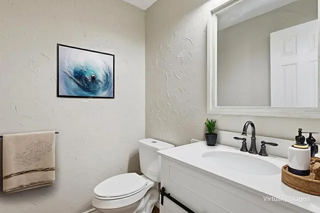 a spacious bedroom with a large bed and a chandelier