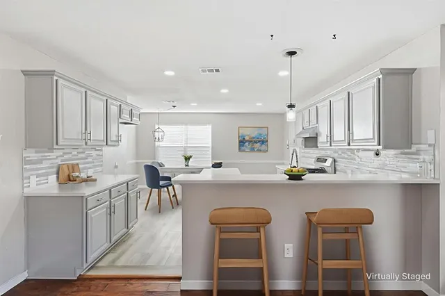 a kitchen with a sink a stove a refrigerator and cabinets