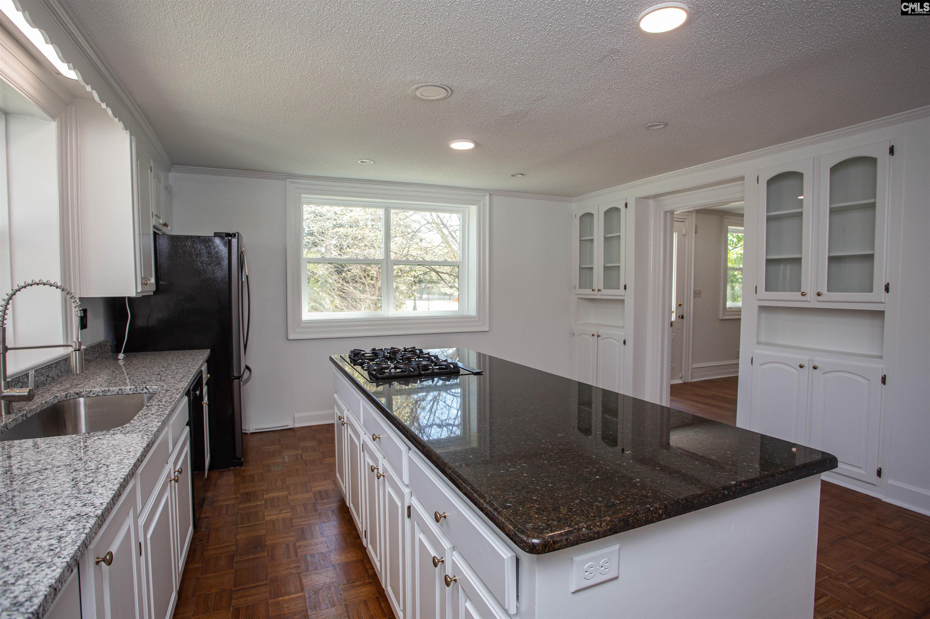 1700 Broad Street Camden, SC 29020 - Photo 9 of 41 a kitchen with granite countertop stainless steel appliances a sink stove and refrigerator