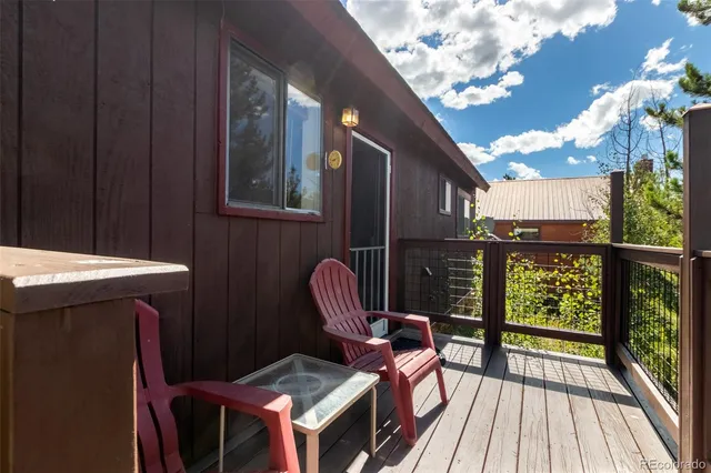 a view of balcony with wooden floor and outdoor seating