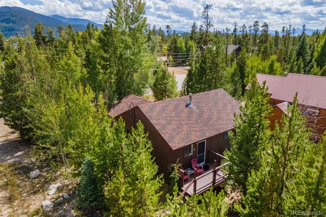 an aerial view of a house with yard and outdoor seating