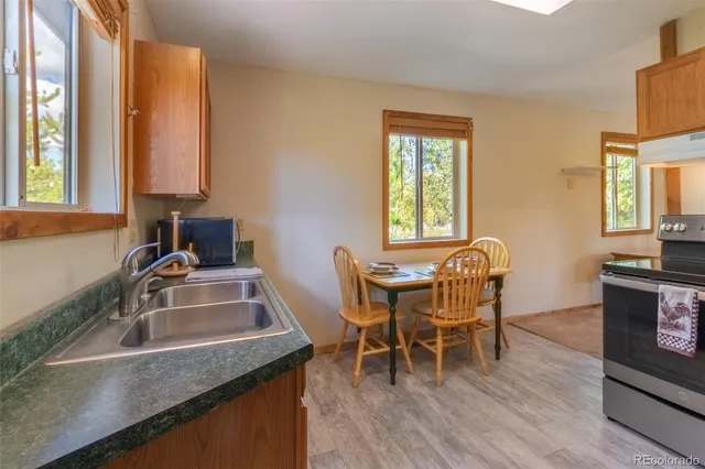 a dining room with furniture and wooden floor