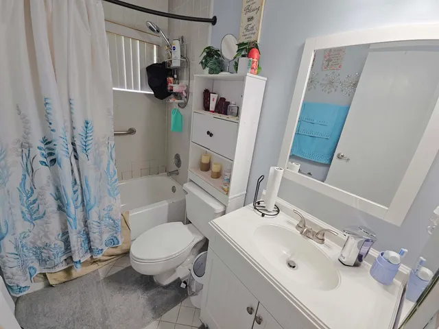 a white toilet sitting next to a bathroom sink