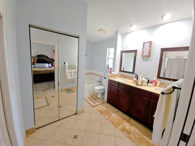 a spacious bathroom with a vanity and a mirror