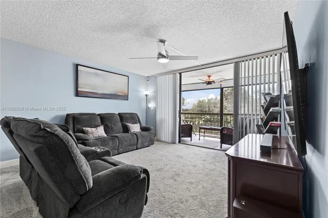a living room with furniture a large window with outer view
