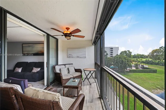 a view of a chair and tables in the balcony