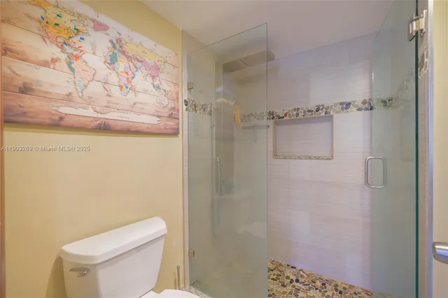 a white toilet sitting next to a shower curtain