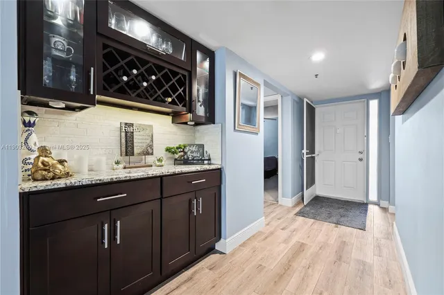a kitchen with stainless steel appliances granite countertop a refrigerator and a sink