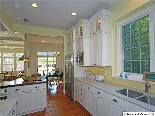 196 Spring Street Red Bank, NJ 07701 - Photo 3 of 3 a large kitchen with granite countertop a large window and white stainless steel appliances