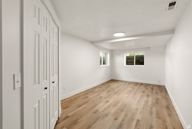 368 Spring Creek Road Providence, UT 84332 - Photo 28 of 45 Unfurnished bedroom with a closet and light wood-style floors
