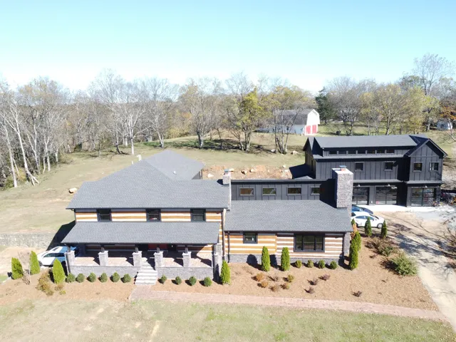 an aerial view of a house with a yard and balcony