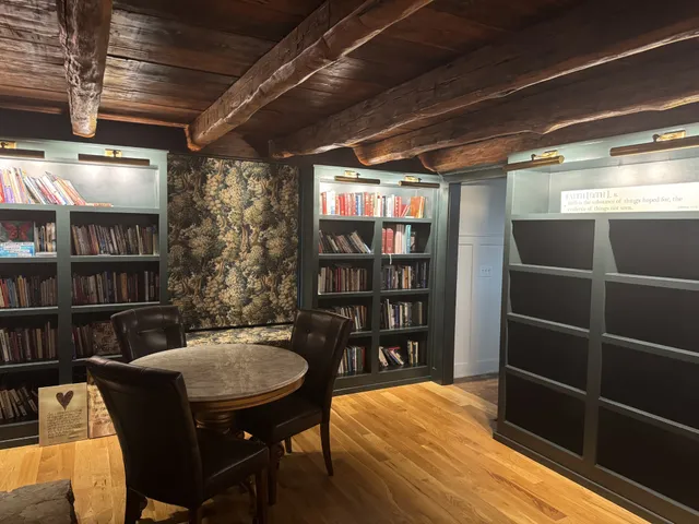 a living room with furniture a rug and a table