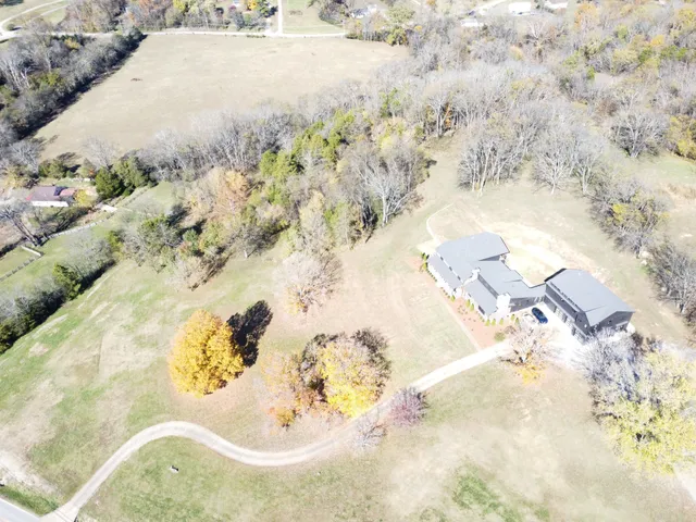 a kitchen with kitchen island granite countertop a sink appliances cabinets and a counter top space