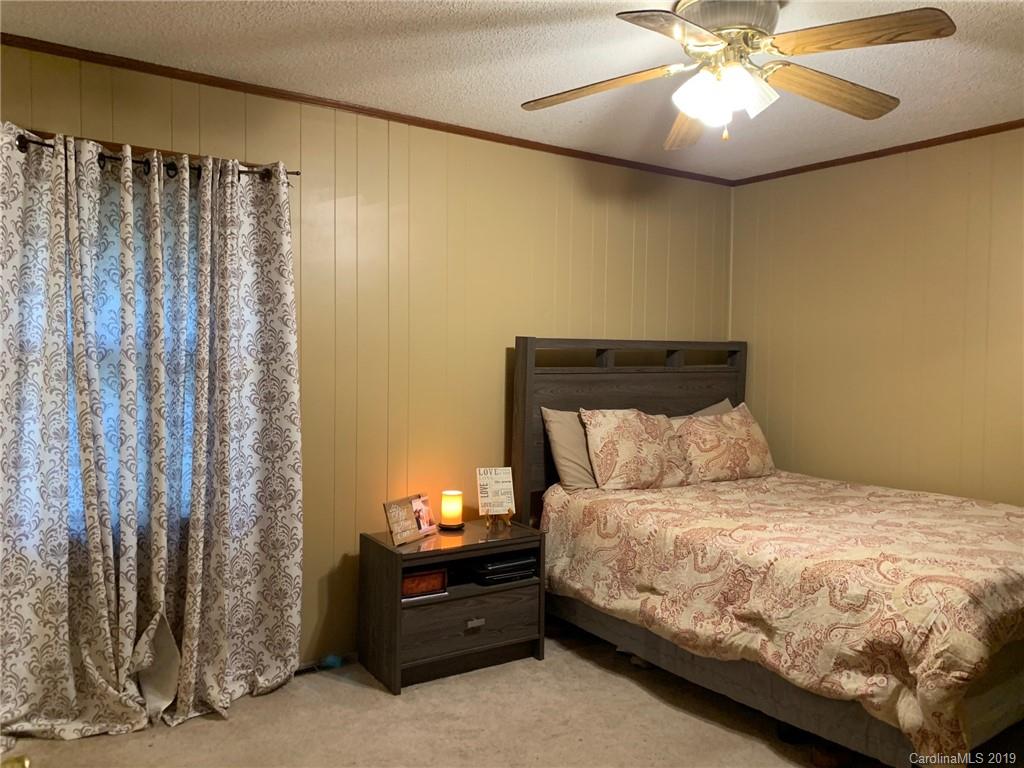 530 South Potter Road Lancaster, SC 29720 - Photo 11 of 21 a bedroom with a bed and a chandelier