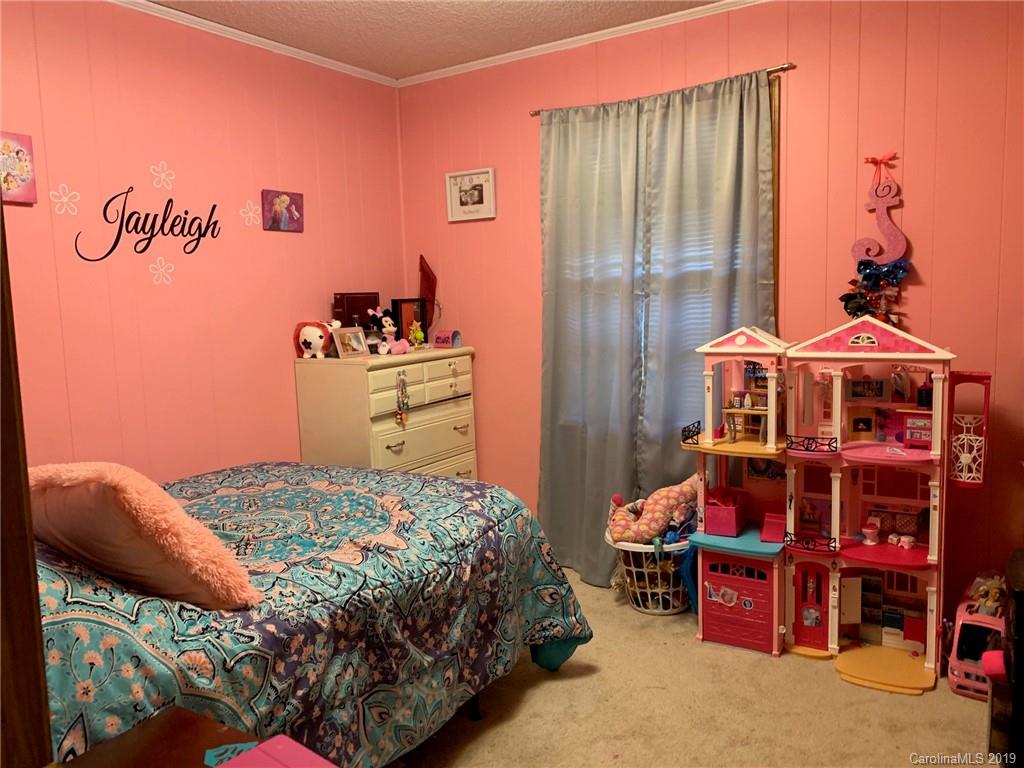 530 South Potter Road Lancaster, SC 29720 - Photo 17 of 21 a bedroom with a bed and a chandelier