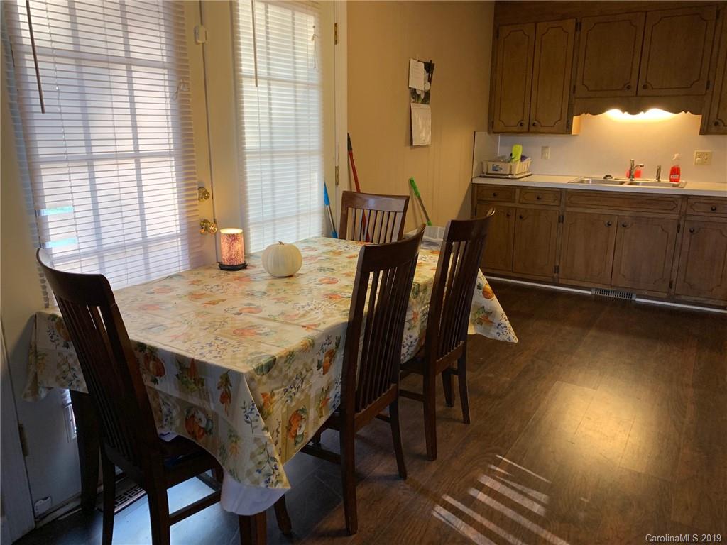 530 South Potter Road Lancaster, SC 29720 - Photo 4 of 21 a kitchen with granite countertop sink dining table and chairs
