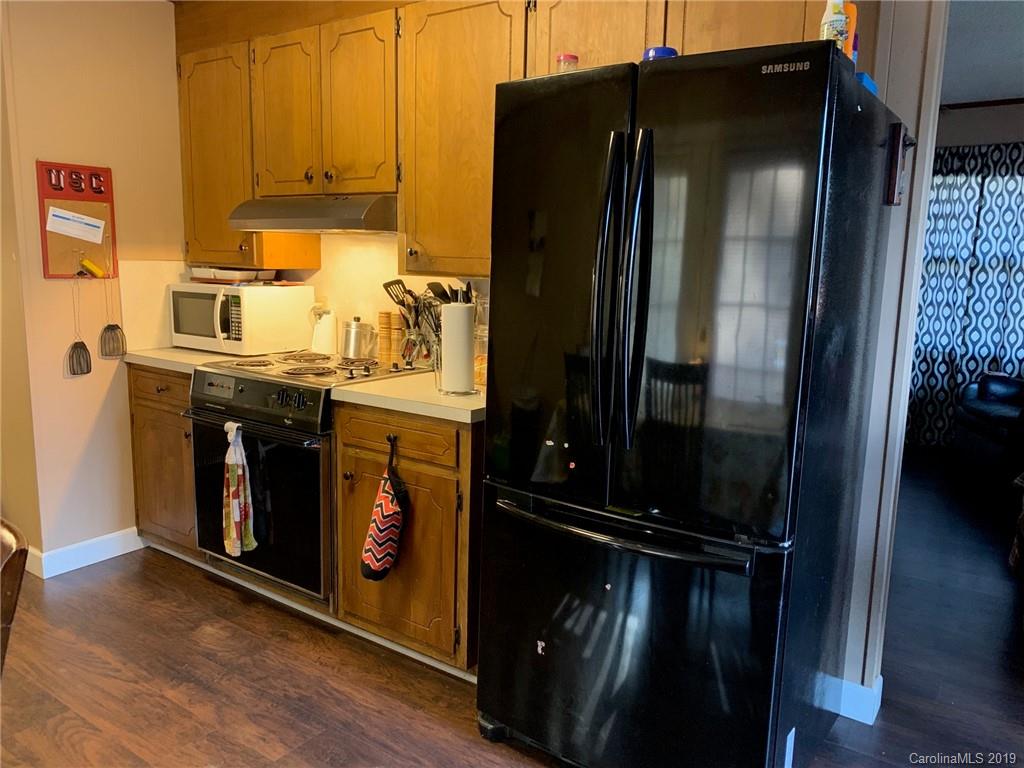 530 South Potter Road Lancaster, SC 29720 - Photo 6 of 21 a kitchen with stainless steel appliances granite countertop a refrigerator a stove and a wooden floor