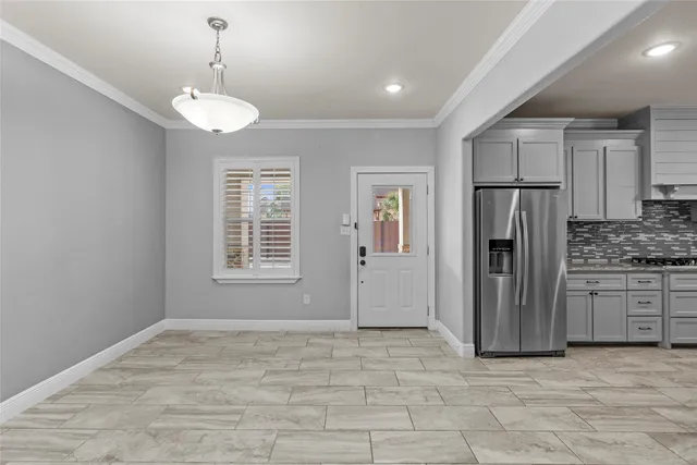 a kitchen with stainless steel appliances a refrigerator and a stove top oven
