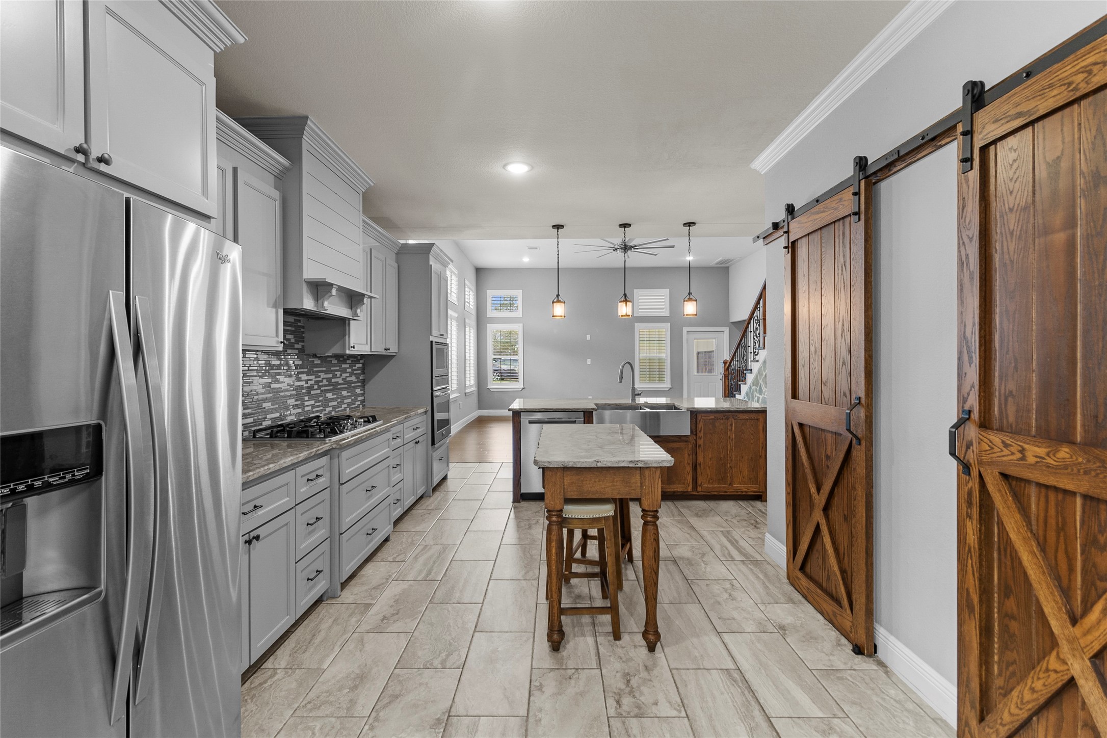 22321 Mossy Oaks Road Spring, TX 77389 - Photo 28 of 50 a kitchen with stainless steel appliances a refrigerator and a stove top oven