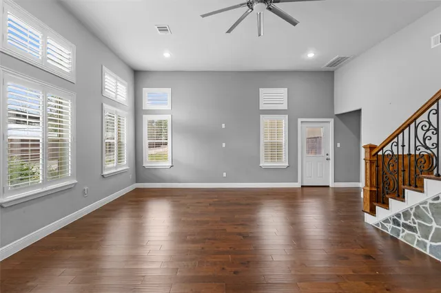 an entryway in a hall with a window and wooden floor