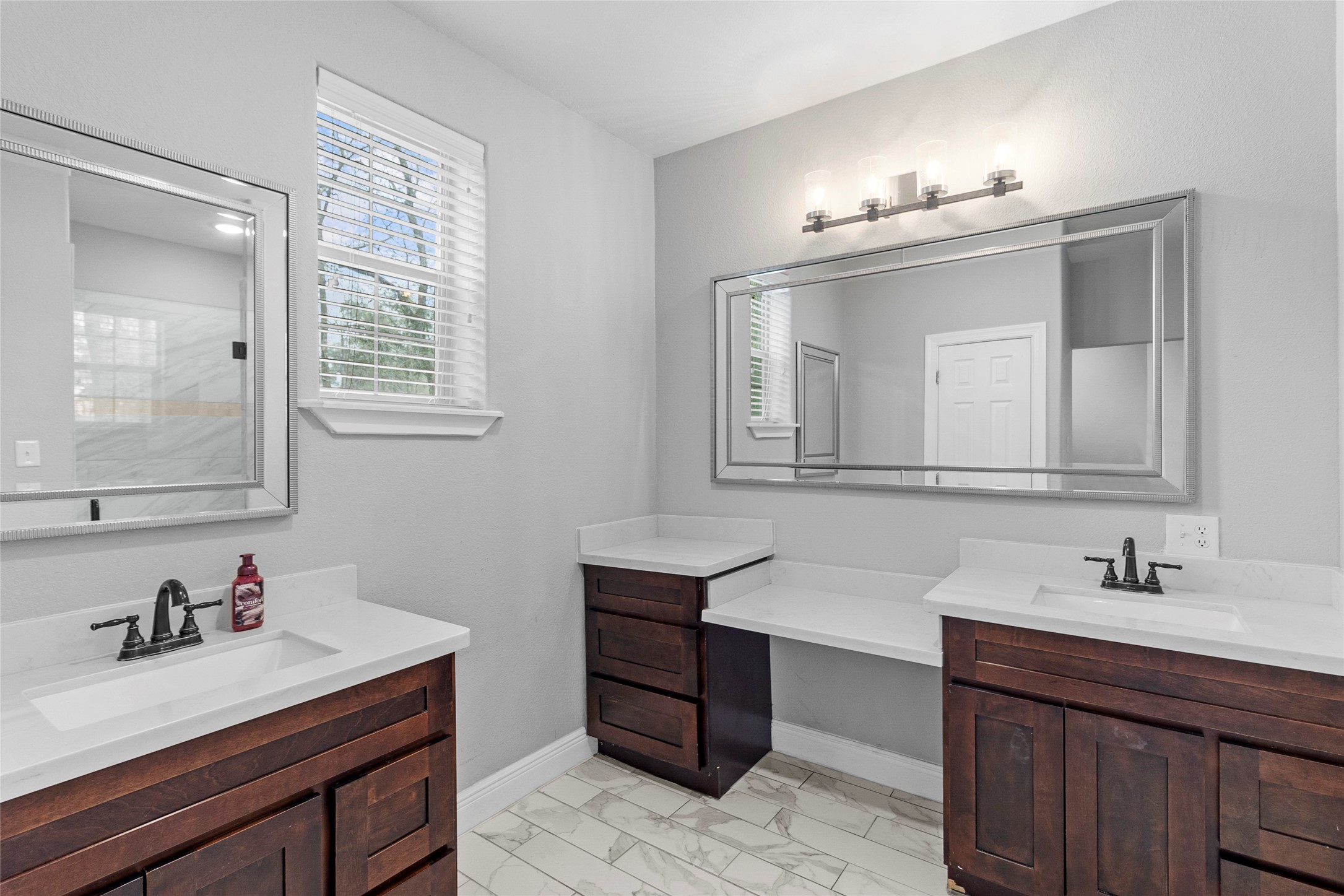 22321 Mossy Oaks Road Spring, TX 77389 - Photo 35 of 50 a bathroom with double vanity sinks and a mirror